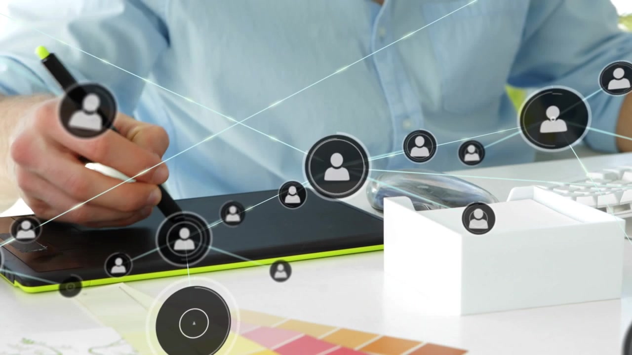 Animation of connected icons over midsection of caucasian man drawing on graphics tablet