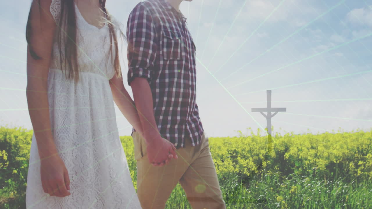 couple walking through yellow wildflowers under sky with lens flares, showing health icons