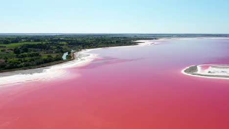 The-historical-town-of-Aigues-Mortes-in-the-Camargue,-France-during-a-sunny-summer-day-which-is-located-next-to-a-pink-salt-lake