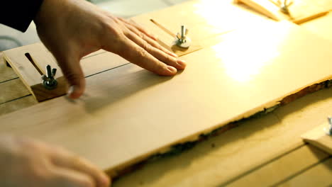 Cnc Drill Is Drilling On The Wooden Plank. In the woodworkers shop the cnc drill is drilling on the wooden plank