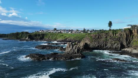 stunning sculptural forms of a towering basalt rock formation above a rugged ocean coastline