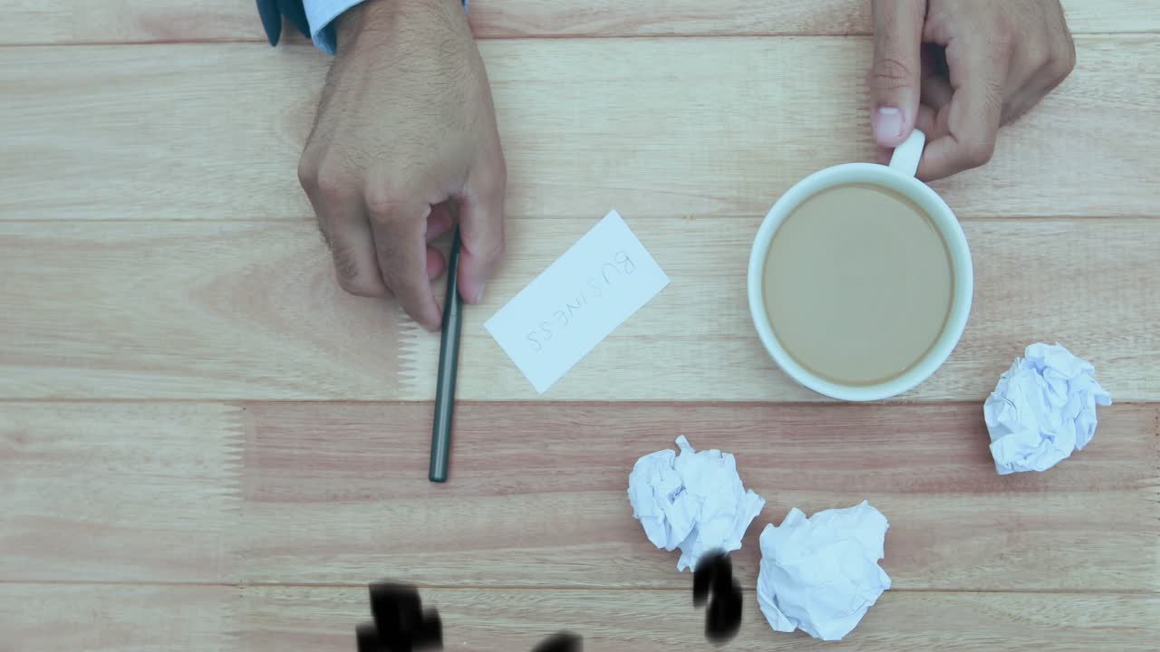 business hand entering frame on desk sending swirling digits inscribing date on card beside coffee