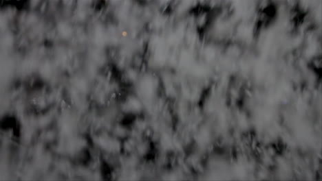 Large-snow-flakes-spinning-during-a-heavy-snow-fall-at-night