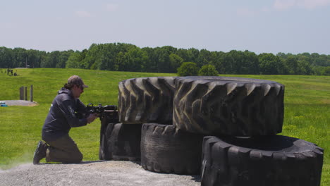 concentrating marksman aims his rifle at precision rifle match in leach, oklahoma