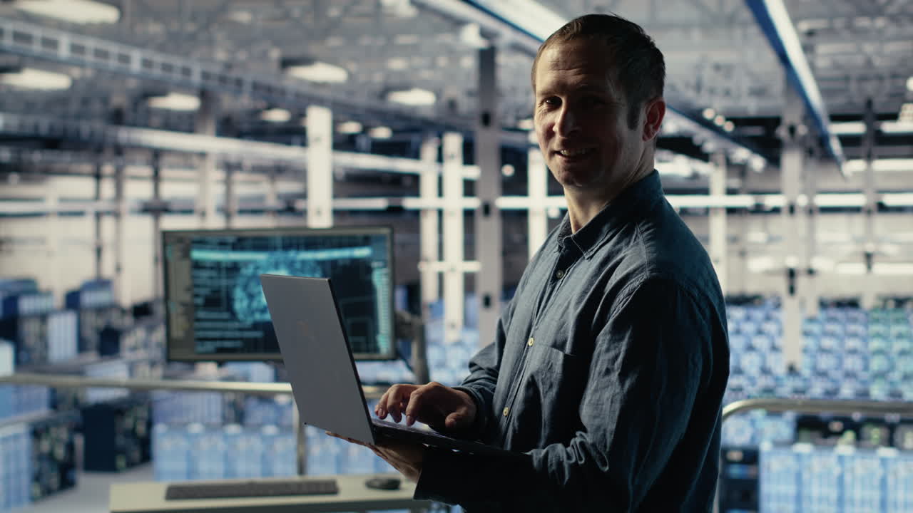 Engineer In Data Center Checks Ai Dashboard Using Laptop During Systems Review