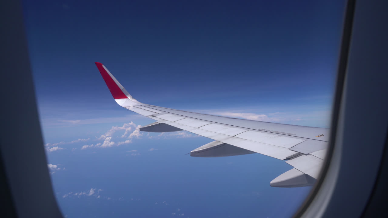 Clouds and sky as seen through window of an aircraft