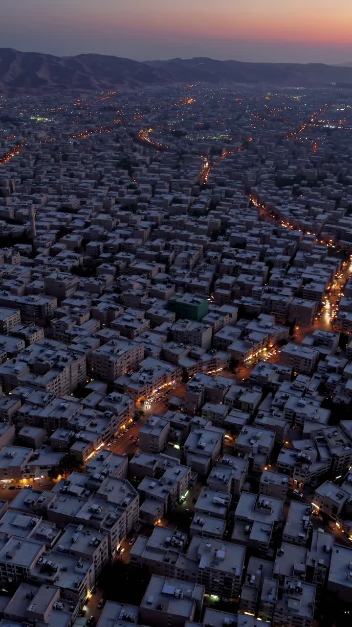Amman, the vibrant capital of Jordan, glowing as dusk descends, reveals a stunning urban landscape beneath a colorful sky, highlighting its unique skyline and bustling streets
