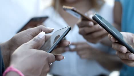 closeup shot of hands texting on modern phones