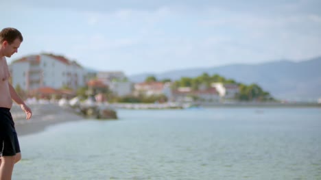 Junger-Mann-Tourist-Zu-Fuß-Am-Meer-Im-Sommer-1