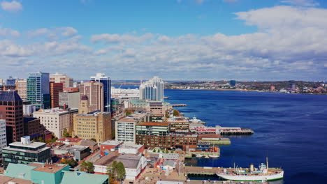aerial drone shot over halifax downtown, nova scotia, canada.
high view of the cityscape, ocean and the urban buildings.