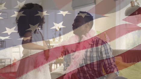 animation of flag of united states of america over african american father and daughter having fun