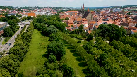 4k aerial drone video of the frankische rezat river in downtown ansbach, germany with the st