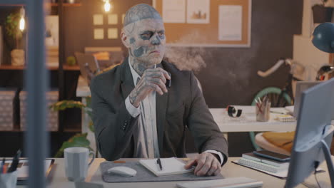 tattooed businessman in office
