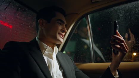 smiling employee video call smartphone auto close up. businessman greeting hand