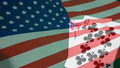 animation of playing cards over american flag waving