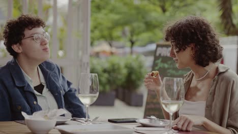 friends enjoying a meal and conversation at an outdoor restaurant
