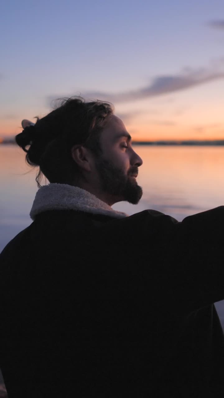 Man with Guitar Taking a Selfie at Sunset by the Water