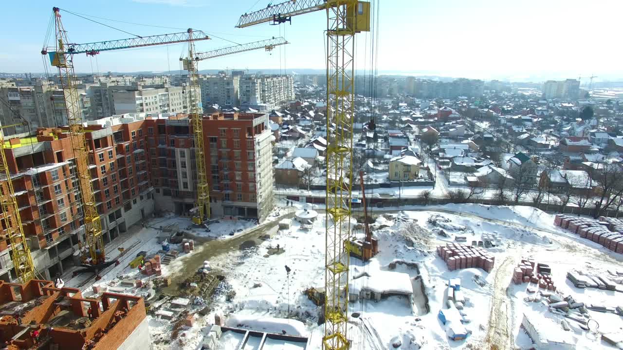 Construction of modern building. Aerial view of high construction building with cranes
