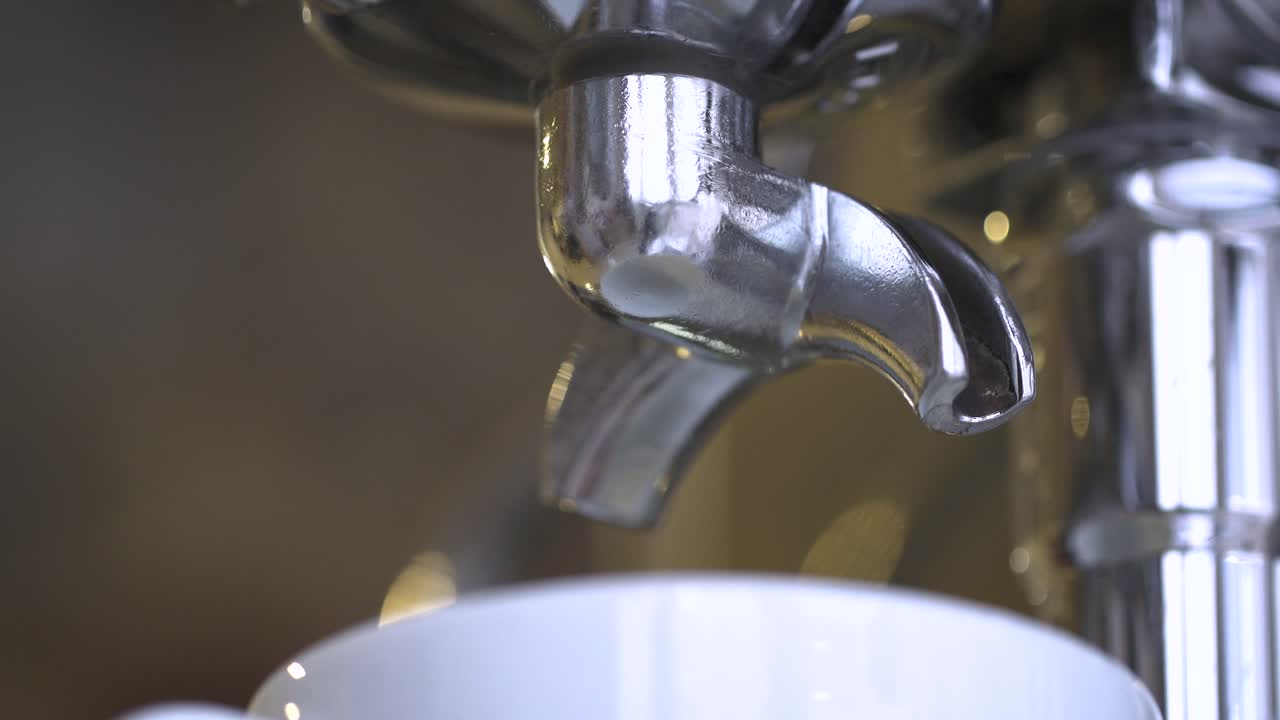 Espresso pouring into a cup from a coffee machine