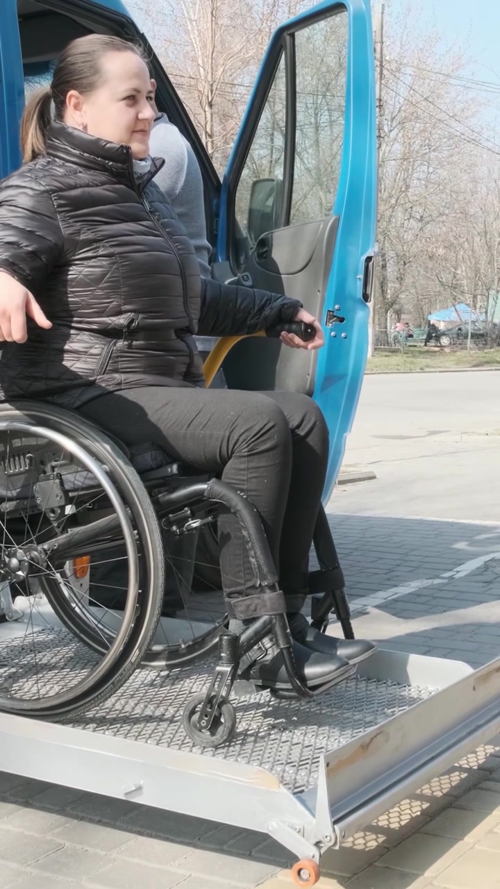 Woman in Wheelchair Using Accessible Van Lift
