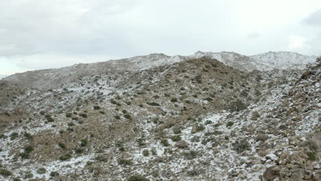 flying over the hills of joshua tree dusted with snow