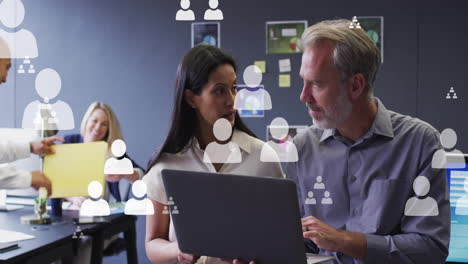 animation of people icons over diverse business people in office