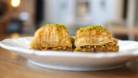 close up of two pieces of baklava on a white plate