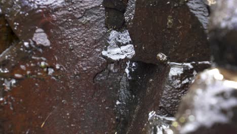 4k clip of water trickling down rocky surface