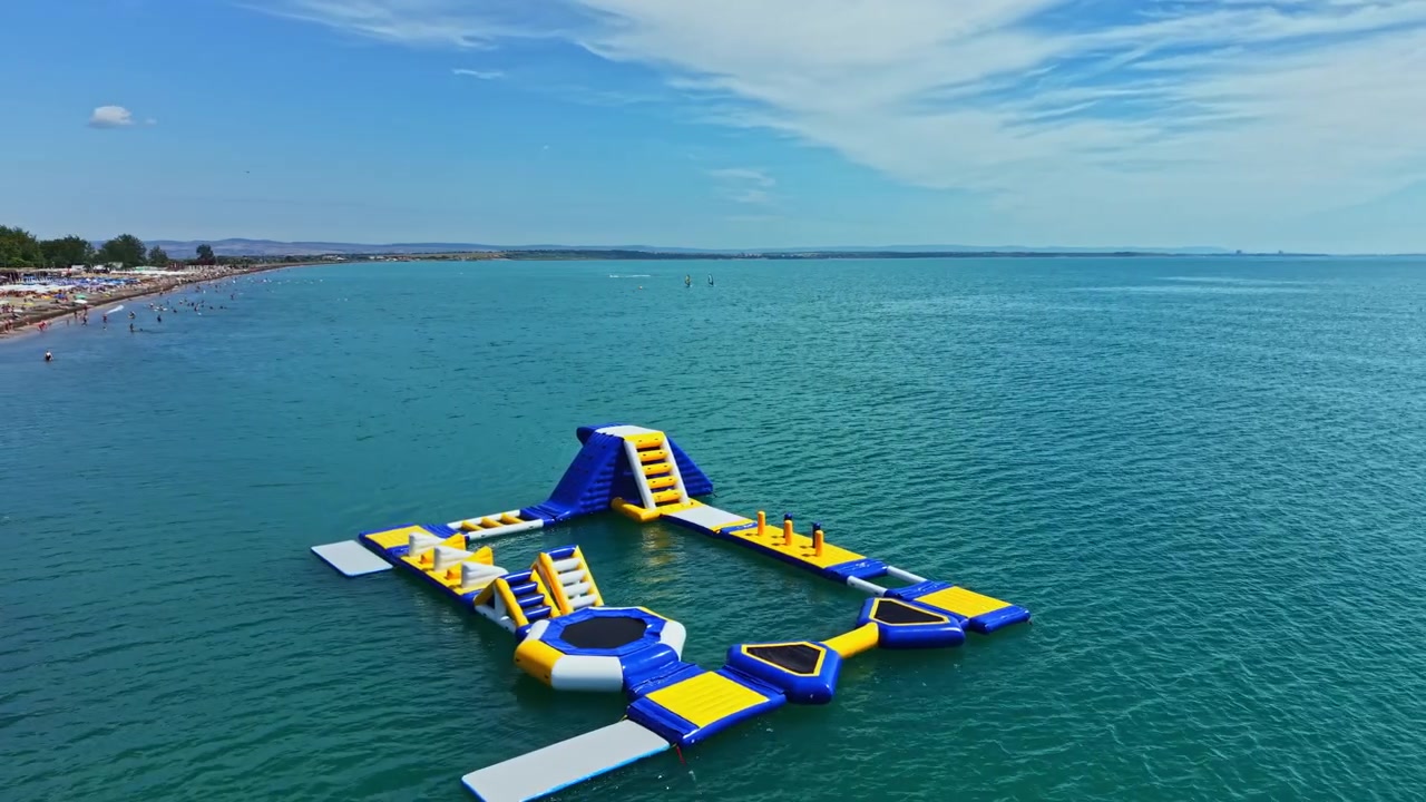 Water park with inflatable structures on calm sea in sunny weather during daytime
