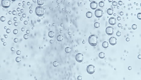 water bubbles with white background, static bubbles in the foreground and fast moving smaller bubbles in the background