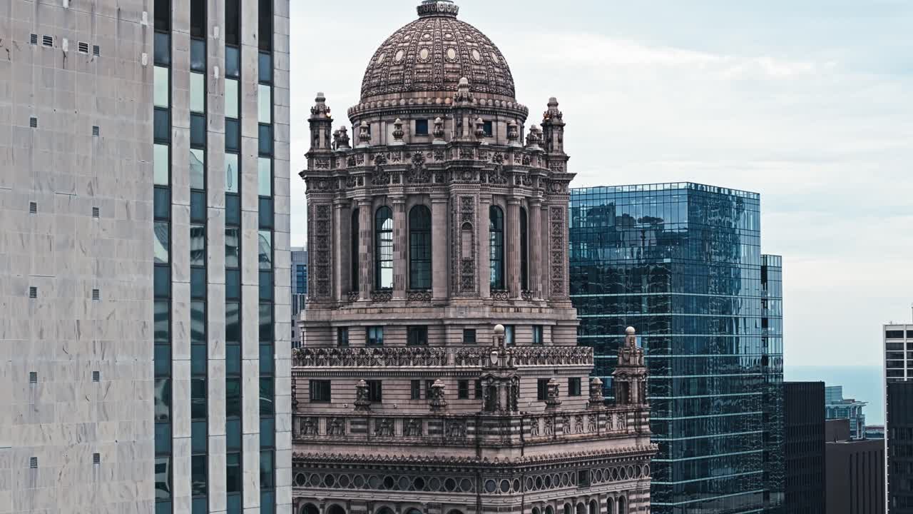 Aerial telephoto ascend of Chicago’s iconic skyline with a focus on old historic Tower and surrounding modern buildings