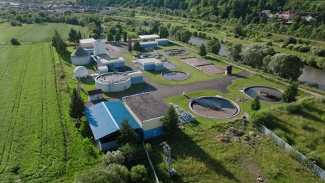 aerial view of small wastewater treatment plant with green grass