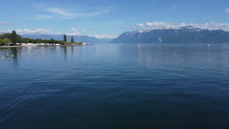 Aerial-rise-above-kayakers-on-Lake-Geneva-near-Lausanne,-Switzerland-on-a-sunny-day