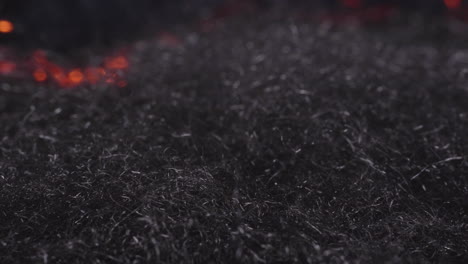 fire waves creeping through steel wool -close up