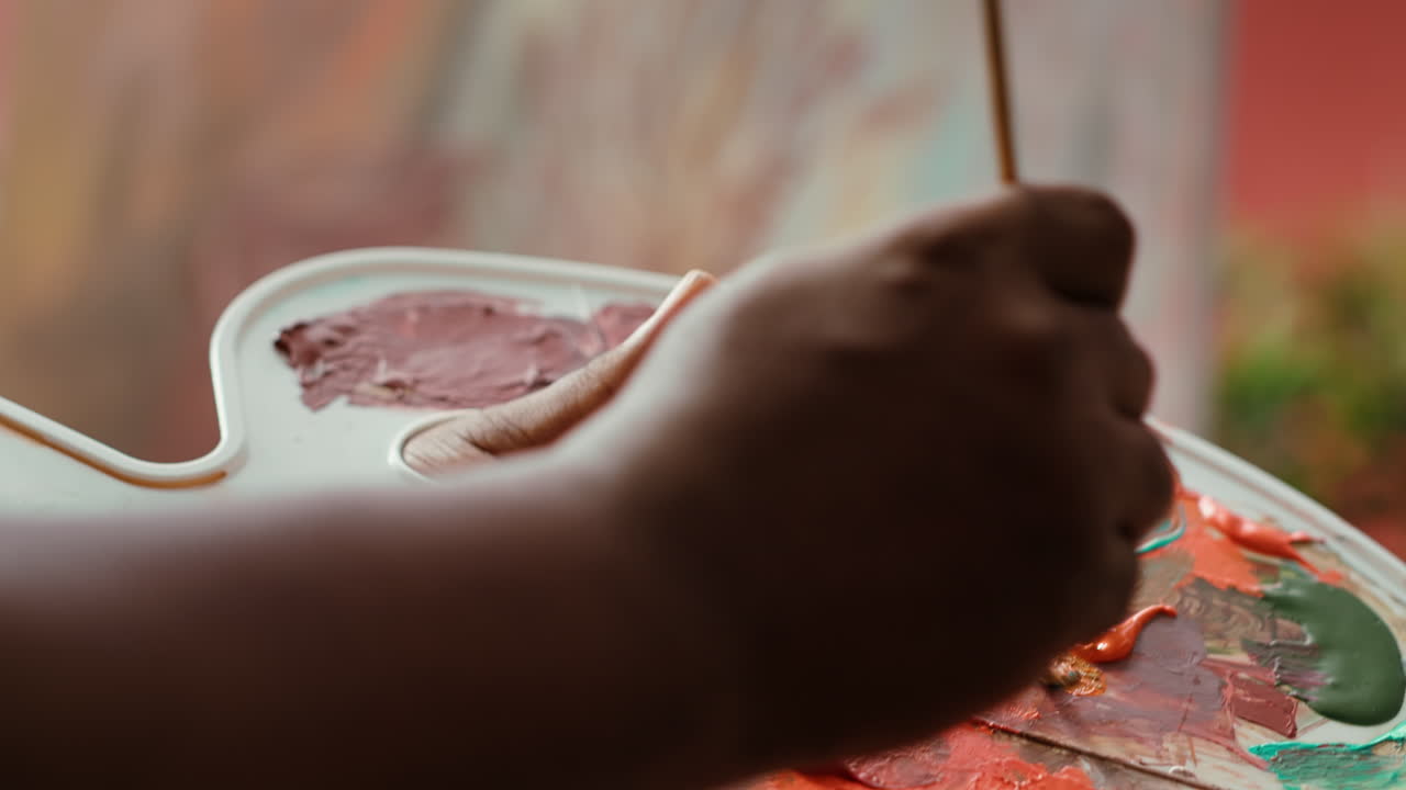 Close-up of a painter's palette with various colors of paint
