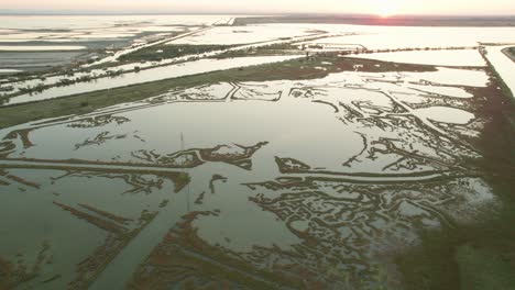 The-Valli-di-Comacchio-lagoon-and-wetland,-Comacchio,-Italy,-drone-view-during-day