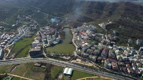 tirana's outskirts captured by drone, revealing new resorts sprouting amidst the city's expanding suburbs