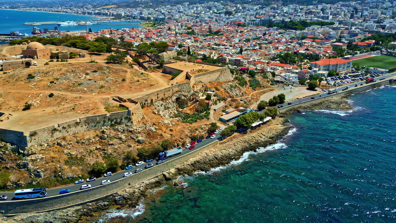 Rethymno on Crete, Greece with the Venetian Fortezza Castle citadel on a peninsula overlooking the harbor - aerial parallax