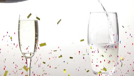Animation-of-multi-coloured-confetti-falling-over-two-champagne-flutes