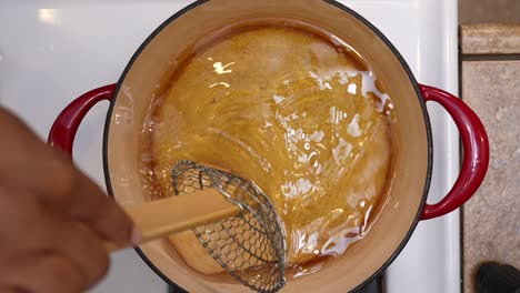 top down view of frying bhatura bread dough in hot oil - chana masala series
