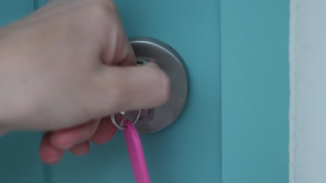female opening and unlocking door before entering home. security concept