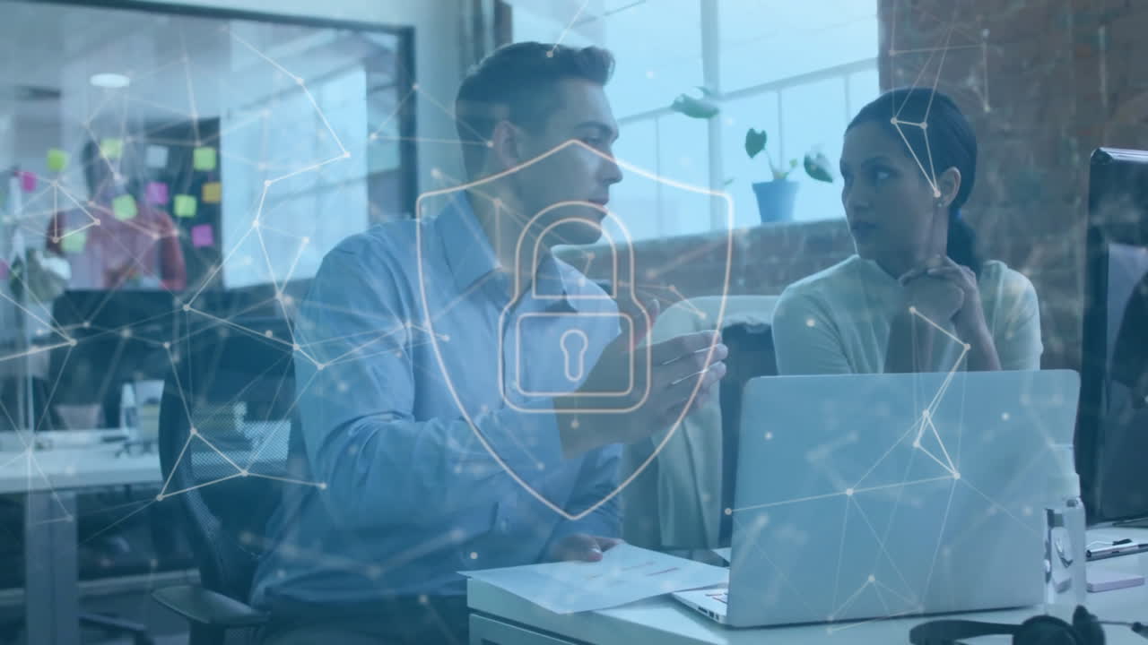 Animation of padlock in shield, connected dots over diverse coworkers discussing report on laptop