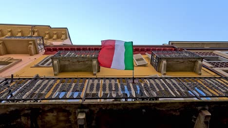 italian flag waving on a balcony in piedmont