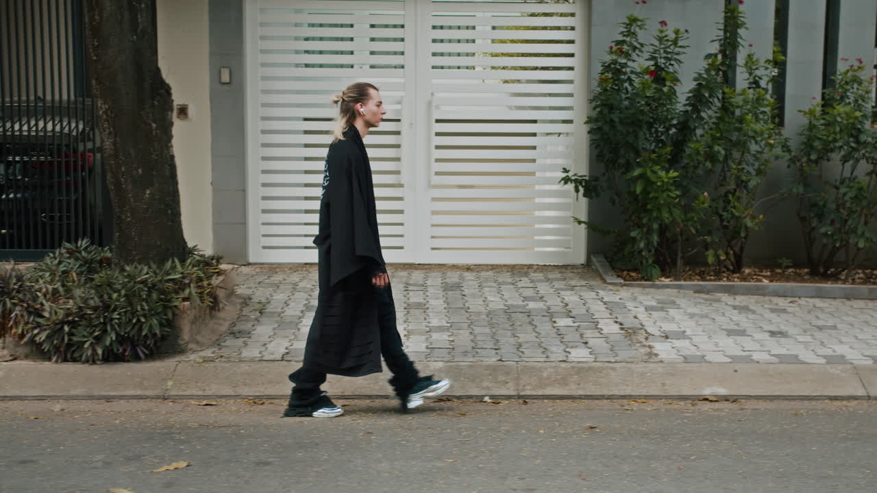 Male Model in Trendy Black Clothes Walking along Street