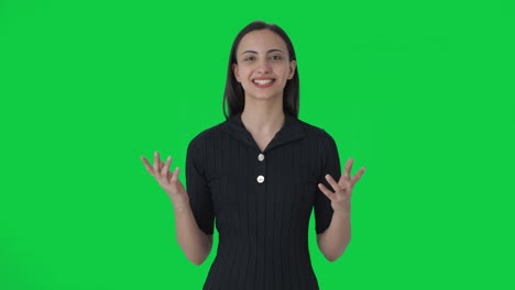 Happy-Indian-female-anchor-delivering-the-news-on-tv-Green-screen