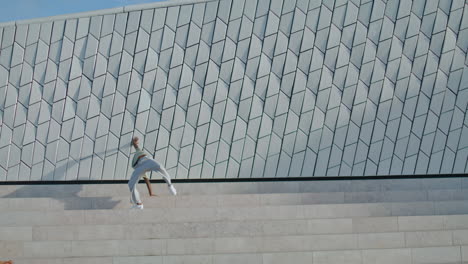 dancing performer rehearsing street vertically. freestyle man practicing dance