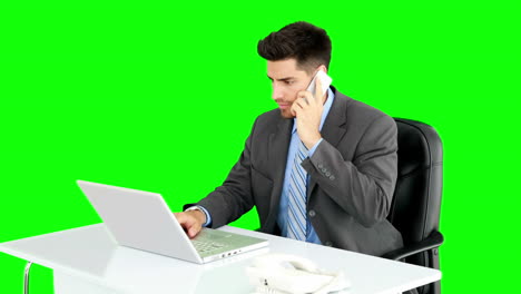 Handsome-businessman-working-at-desk