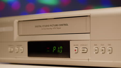 hand loading a vhs tape into a vcr