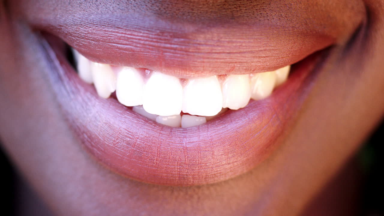 Close up of lips and teeth of  a smiling black woman, detail