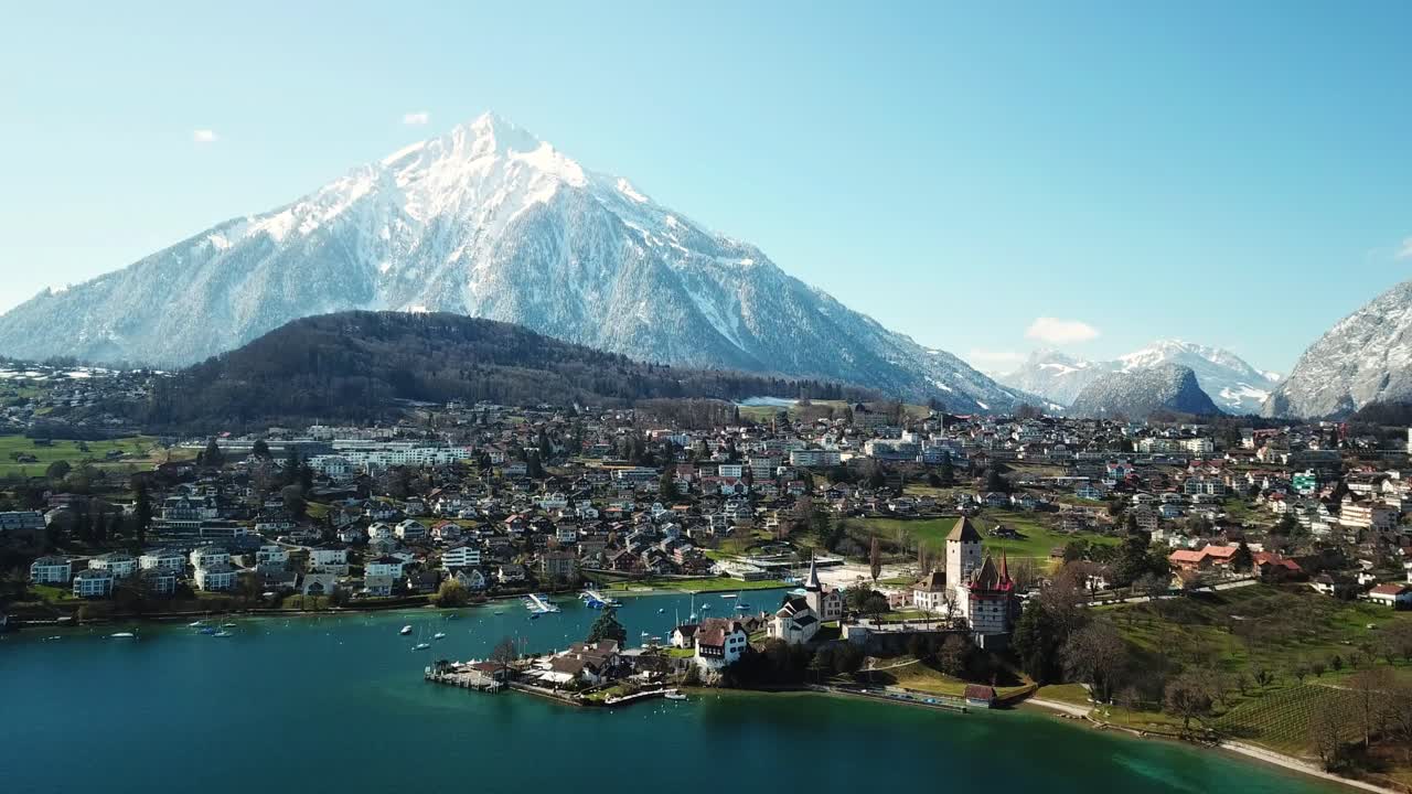 Aerial View of a Castle by a Lake in the Swiss Alps